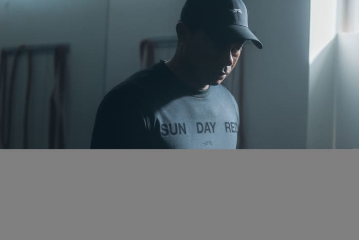 Tiger Woods models a grey Sun Day Red shirt.